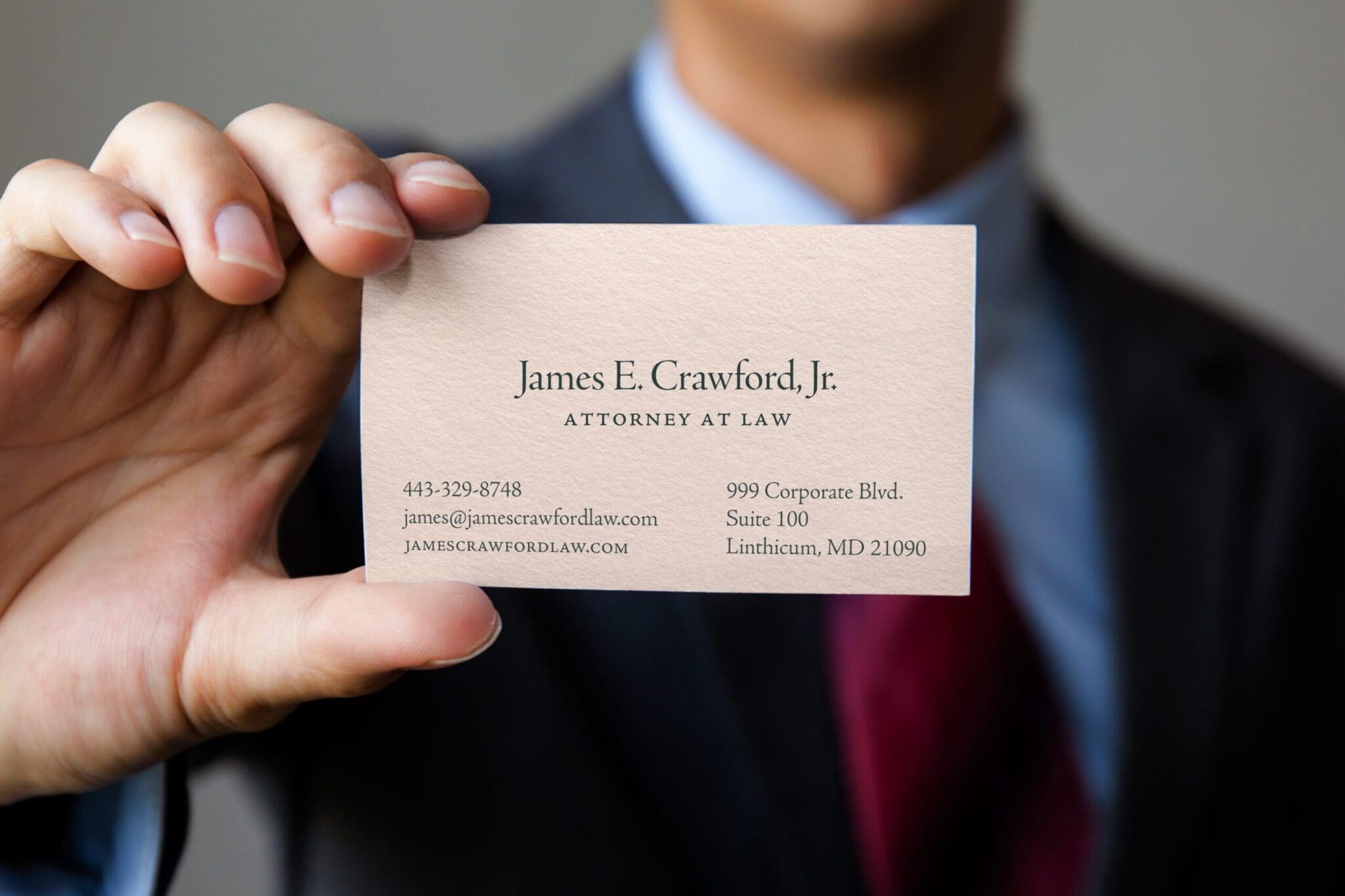 man holding jc law business card
