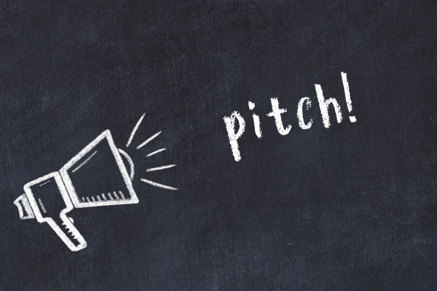 Black chalkboard with drawing of a loudspeaker and inscription pitch